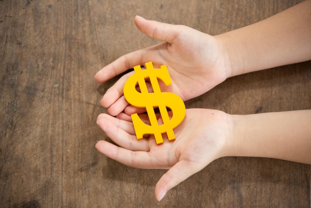 Female hands holding a dollar sign indicating spousal support in divorce